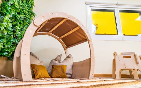 A wooden playhouse in a children's room.