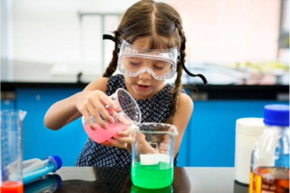 A little girl is working on a science experiment.