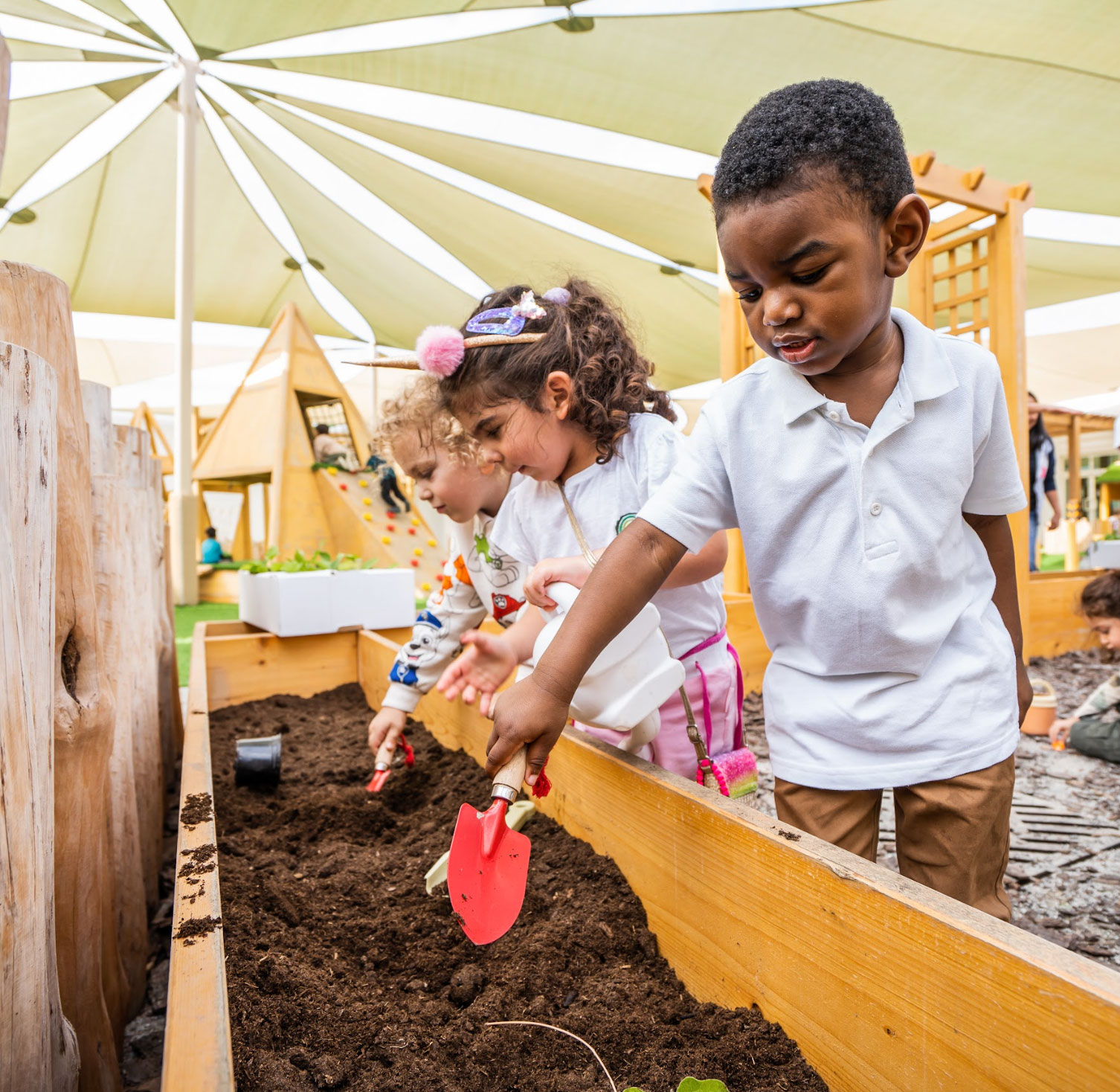 A group of children digging in the dirt.