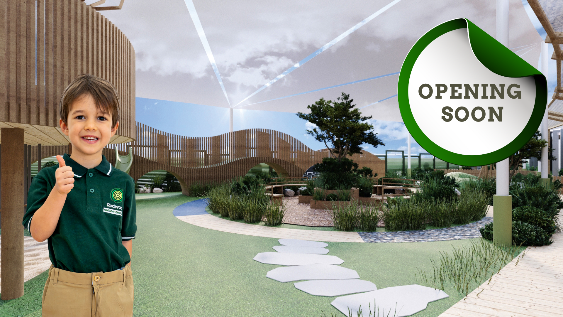 A young boy stands smiling and giving a thumbs up in a landscaped outdoor play area, with a large sign that reads "OPENING SOON" in the background.